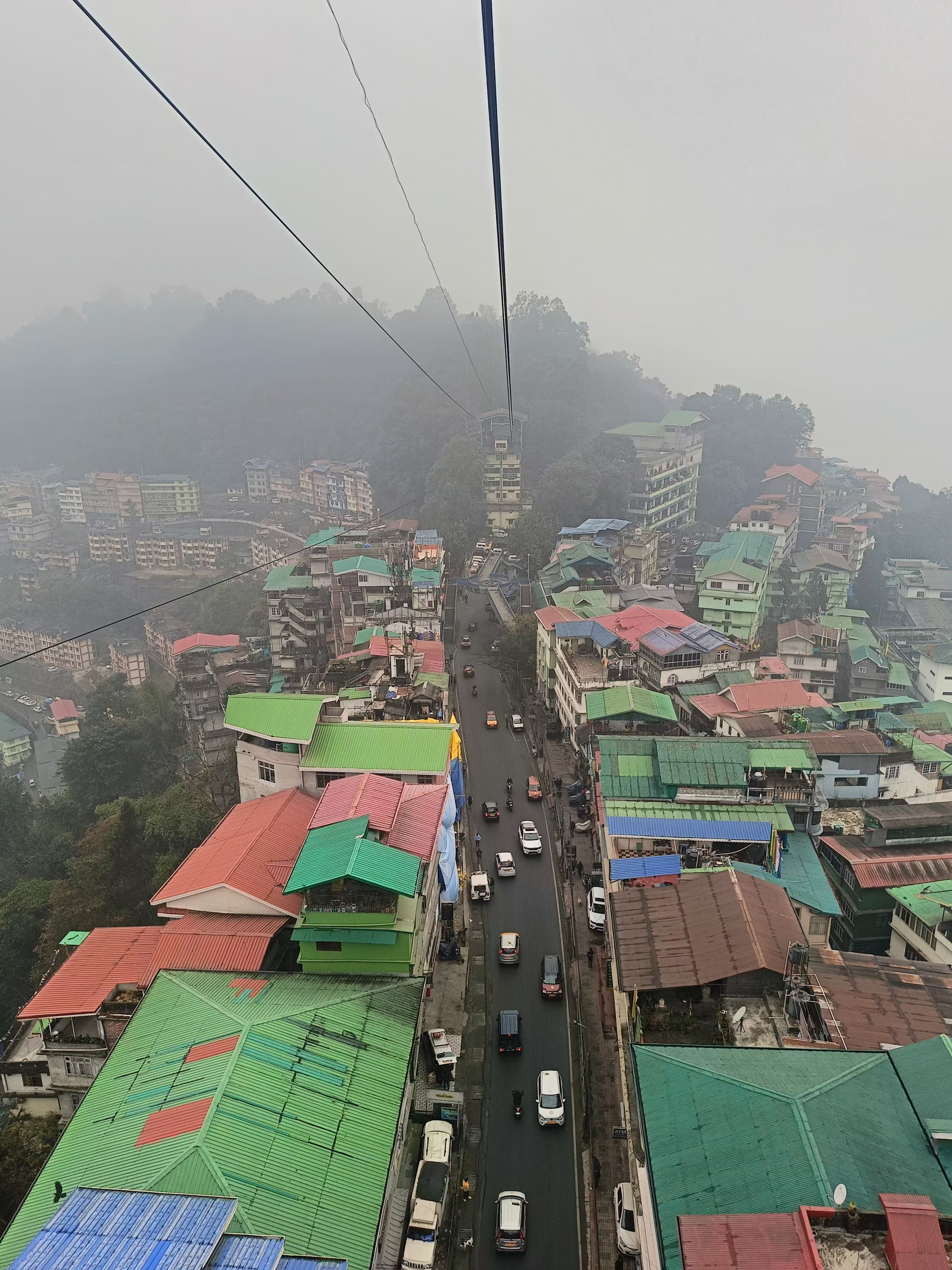 A misty view over Gangtok from the ropeway above the city