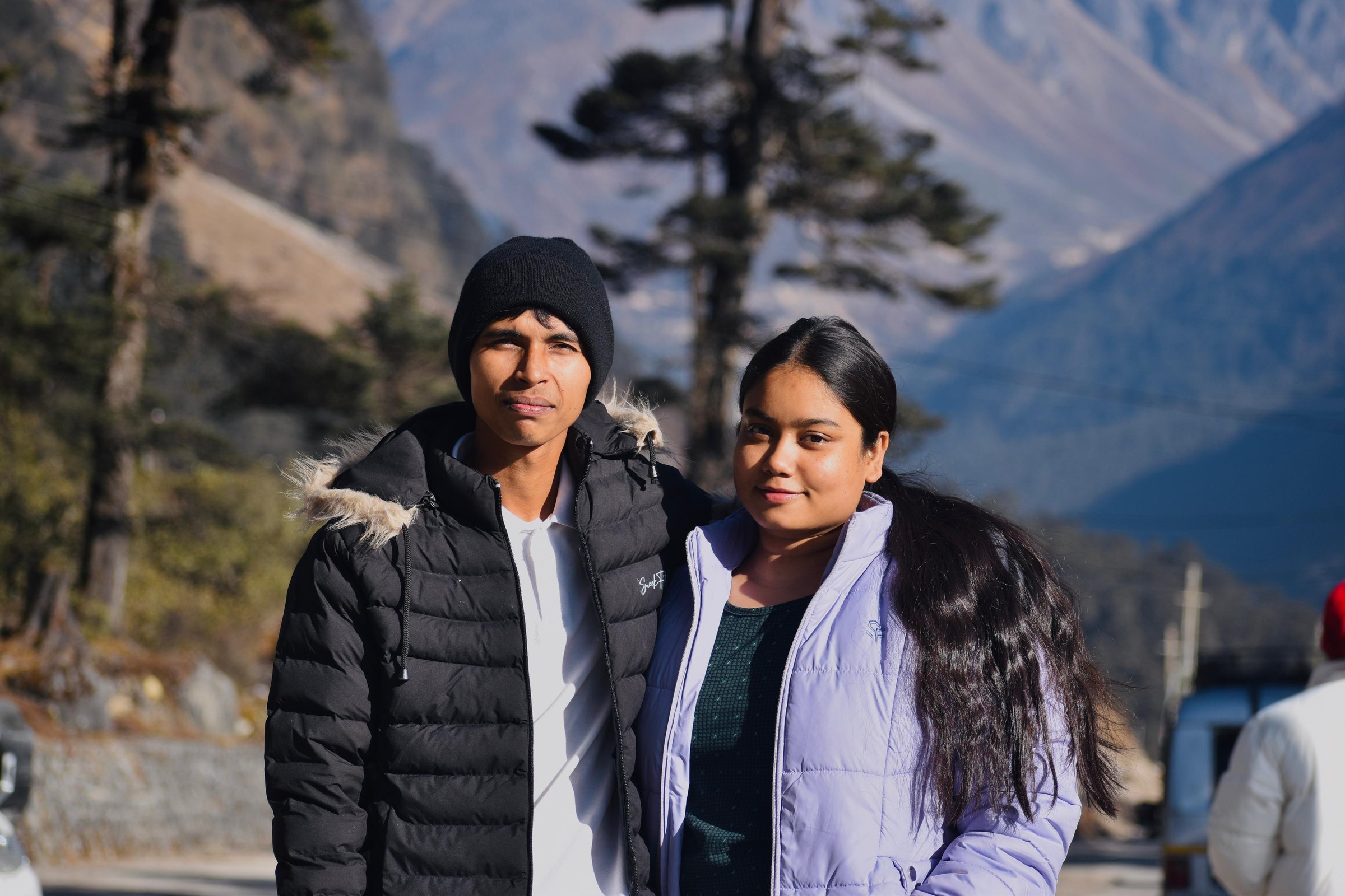 Ashish Alam Kabir and a companion posing in front of a mountain valley